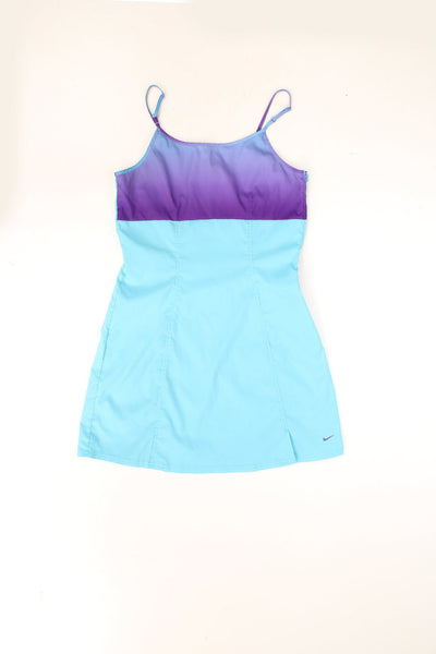 Nike turquoise and purple A-line tennis mini dress with side zip closure and an attached tag featuring a red flower and a Nike swoosh. 