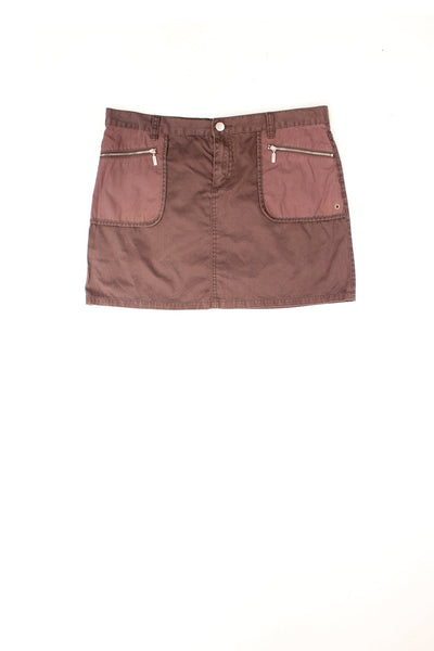 Calvin Klein brown denim skirt with 2 zip-close pockets on the front and one on the back right. 'CK' branded zips and buttons in silver.  