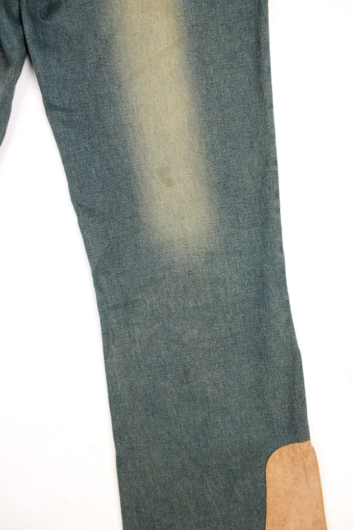 Y2K low rise slit flared jeans in a green-blue stonewash with three pockets and tan faux suede patches on the hem - by Too Hot.