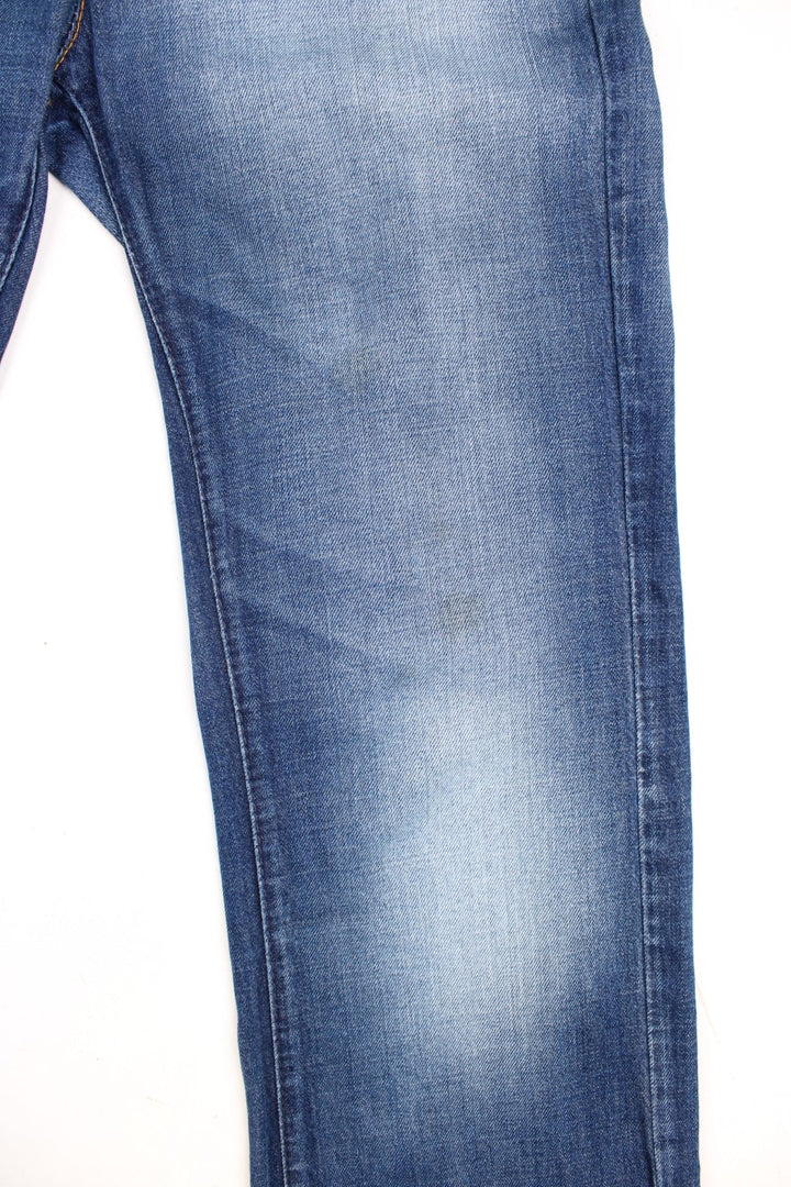 Miss Sixty 'Barbuda' straight leg jeans in a faded blue wash with four pockets, a branded tab on the reverse, and large circular snaps on the front pockets. 