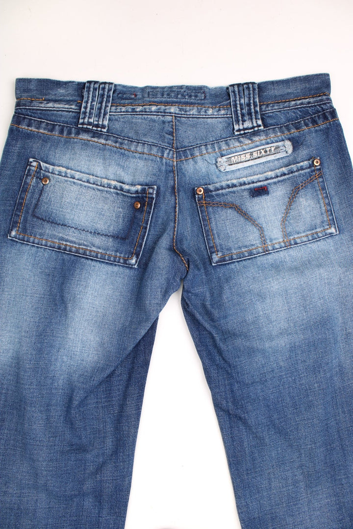 Miss Sixty 'Barbuda' straight leg jeans in a faded blue wash with four pockets, a branded tab on the reverse, and large circular snaps on the front pockets. 