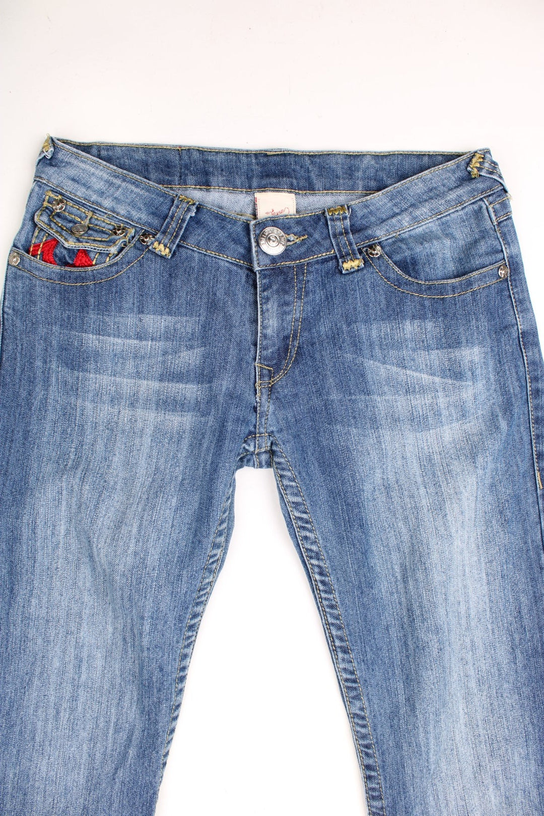 True Religion low rise straight leg jeans in a faded blue wash. Signature horseshoe embroidery in red on back pockets.  