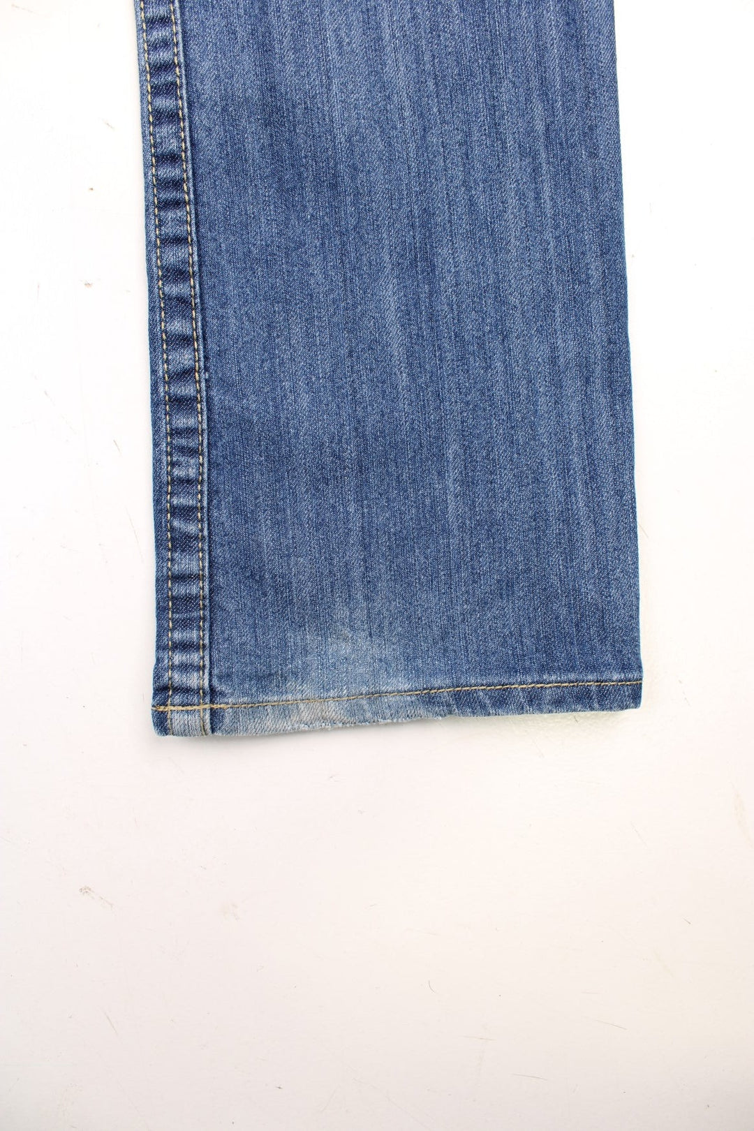 True Religion low rise straight leg jeans in a faded blue wash. Signature horseshoe embroidery in red on back pockets.  