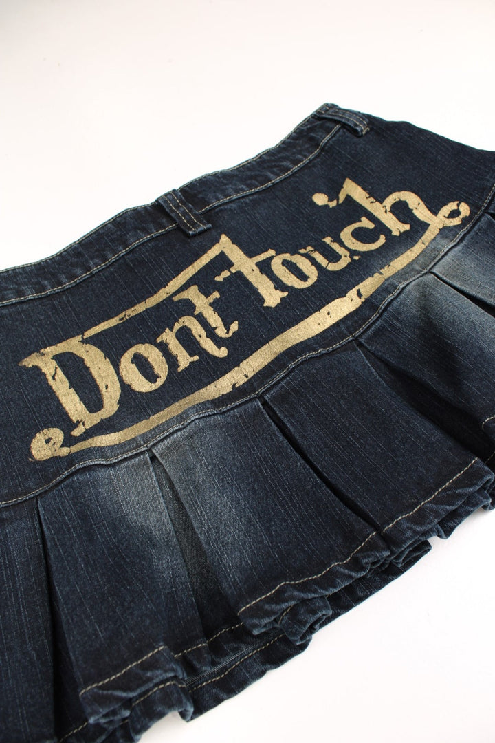 Y2K Mini Skirt in a dark blue denim colourway with 'Don't Touch' printed in gold across back.