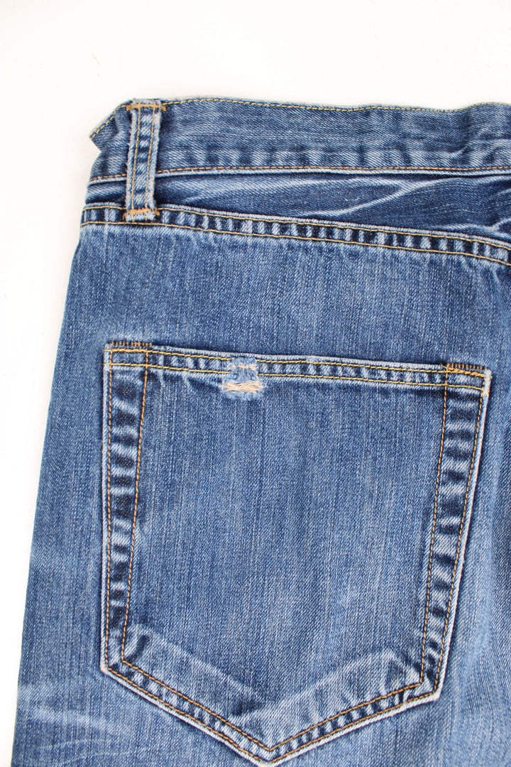 Vintage Y2K Ed Hardy faded effect blue denim Jeans with embroidered spell out logo on the back pocket.  