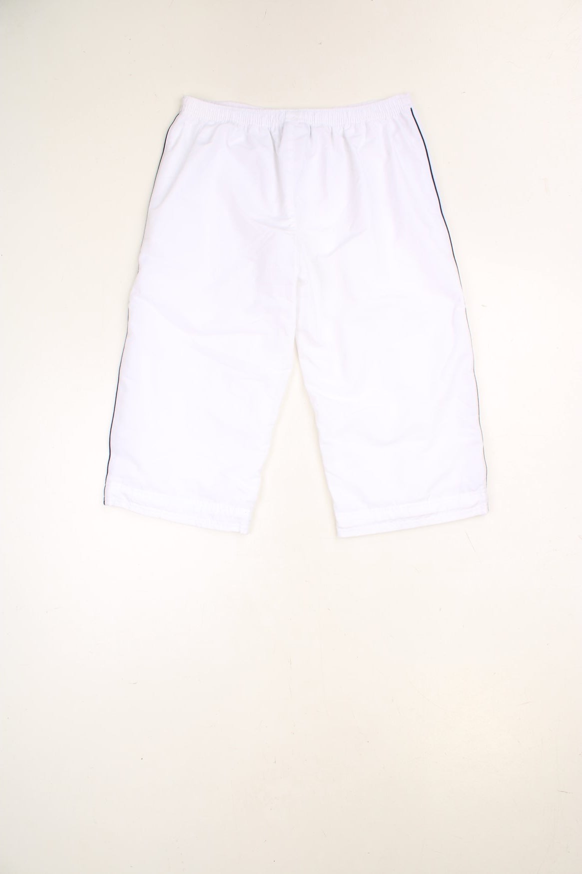 White Reebok Capri Shorts with elasticated, drawstring waist and embroidered spell out logo in blue.