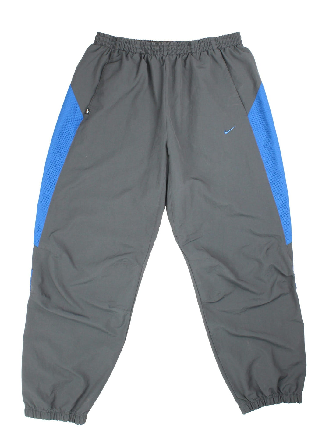 Y2K Nike Tracksuit Bottoms in a grey colourway with blue panels on the sides. Elasticated waist and embroidered swoosh branding.