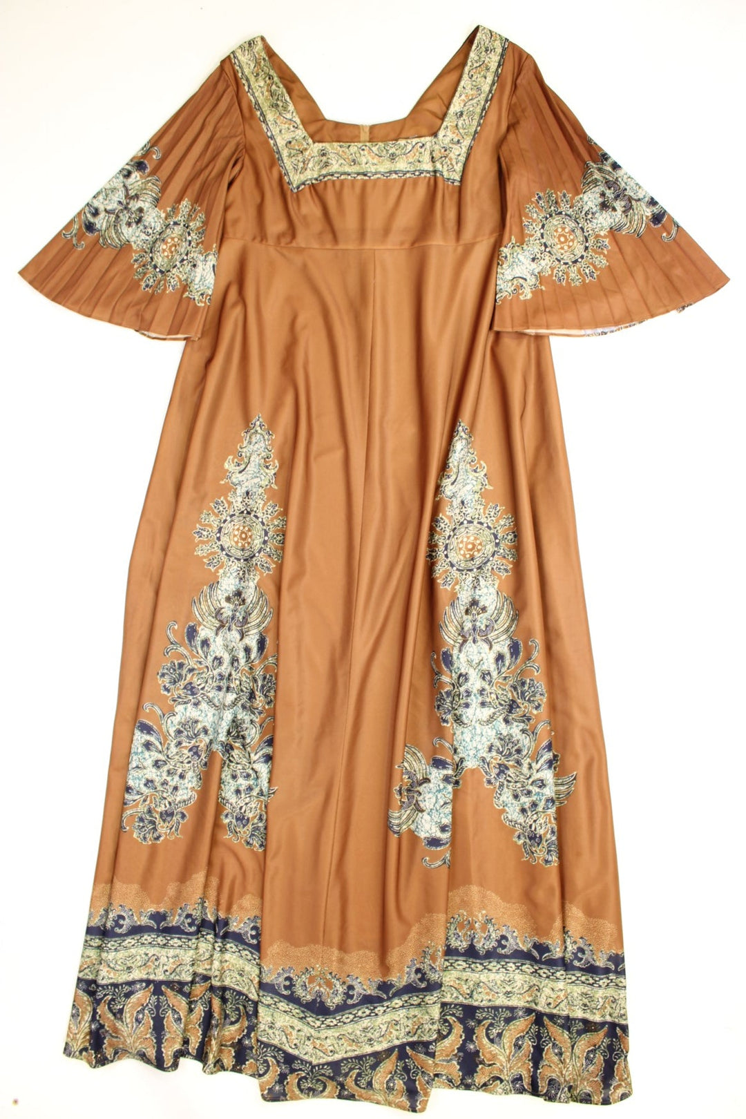 Vintage 70s Chateau D'este floral maxi dress in a brown colourway with pleated sleeves, a blue and green batik print, square neckline and zip closure.