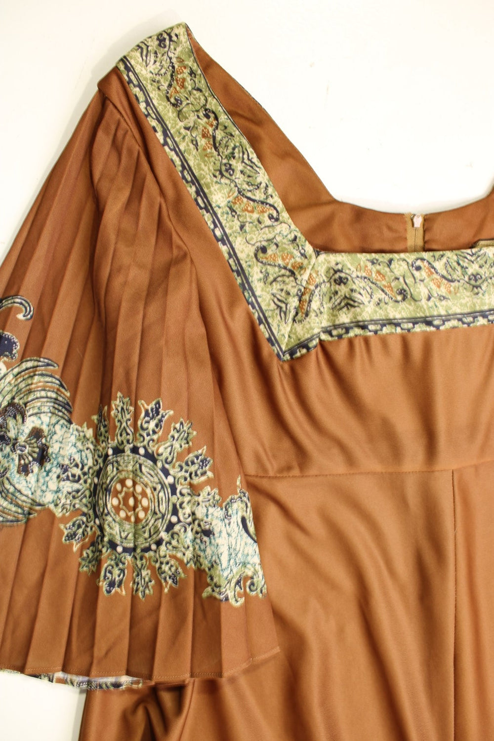 Vintage 70s Chateau D'este floral maxi dress in a brown colourway with pleated sleeves, a blue and green batik print, square neckline and zip closure.