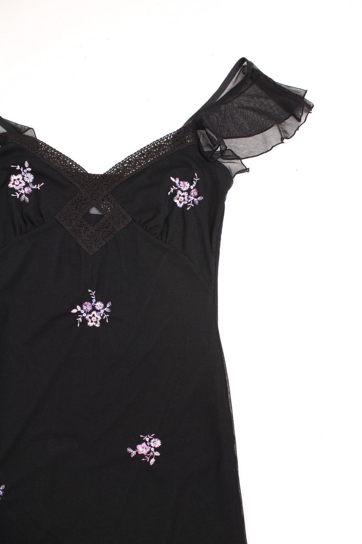 Y2K black v-neck midi dress with lace trim, floral embroidery in pink, and sheer flutter sleeves.  