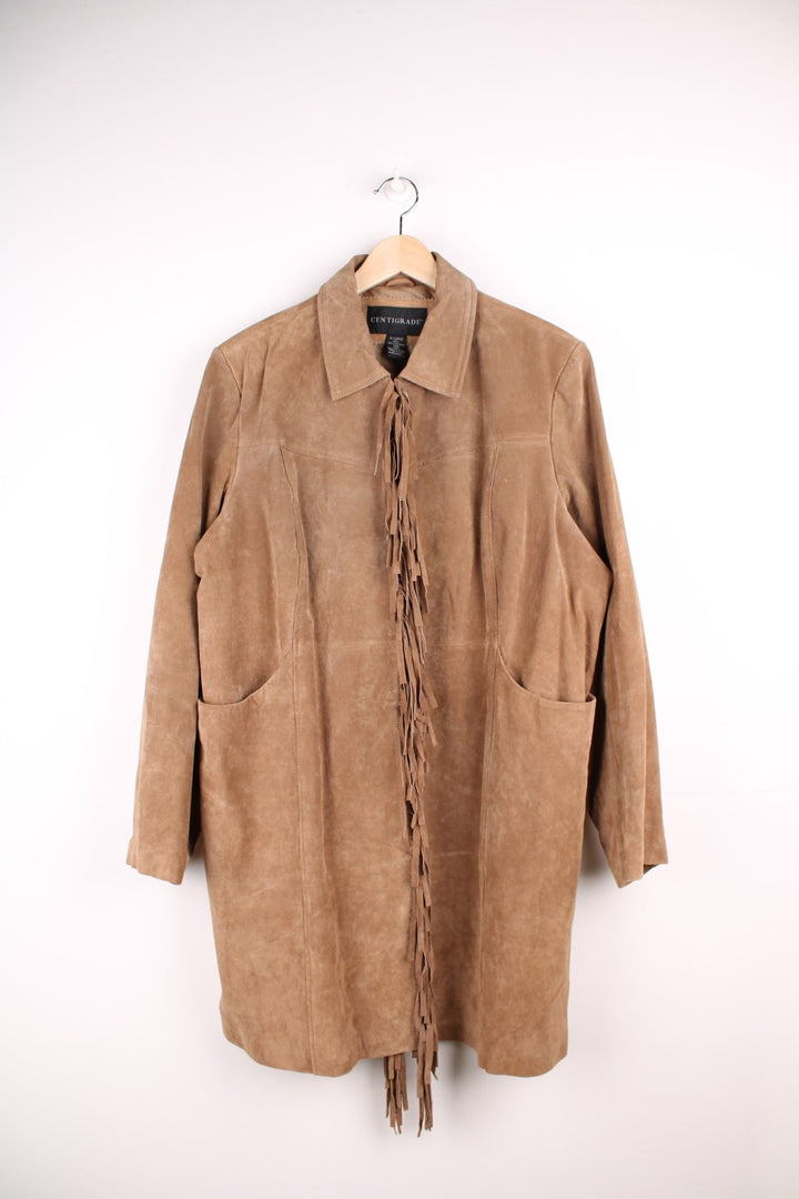 Y2K real suede jacket in tan by Centigrade with hook and eye closure, two pockets, and fringe on the front and back. 