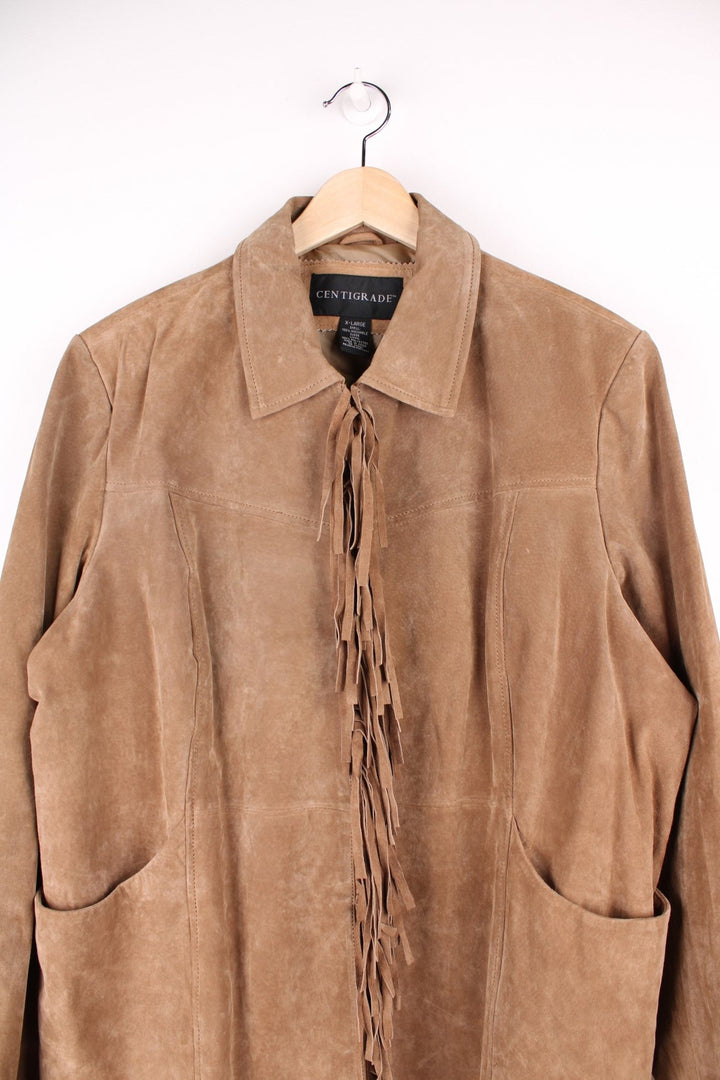 Y2K real suede jacket in tan by Centigrade with hook and eye closure, two pockets, and fringe on the front and back. 