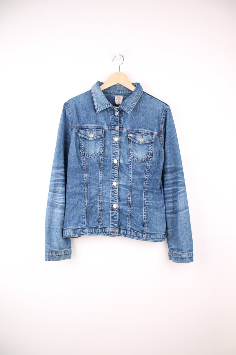 Blue denim jacket by Miss Sixty with button closure and two flap pockets. With small Miss Sixty tags on the chest and lower back hem.