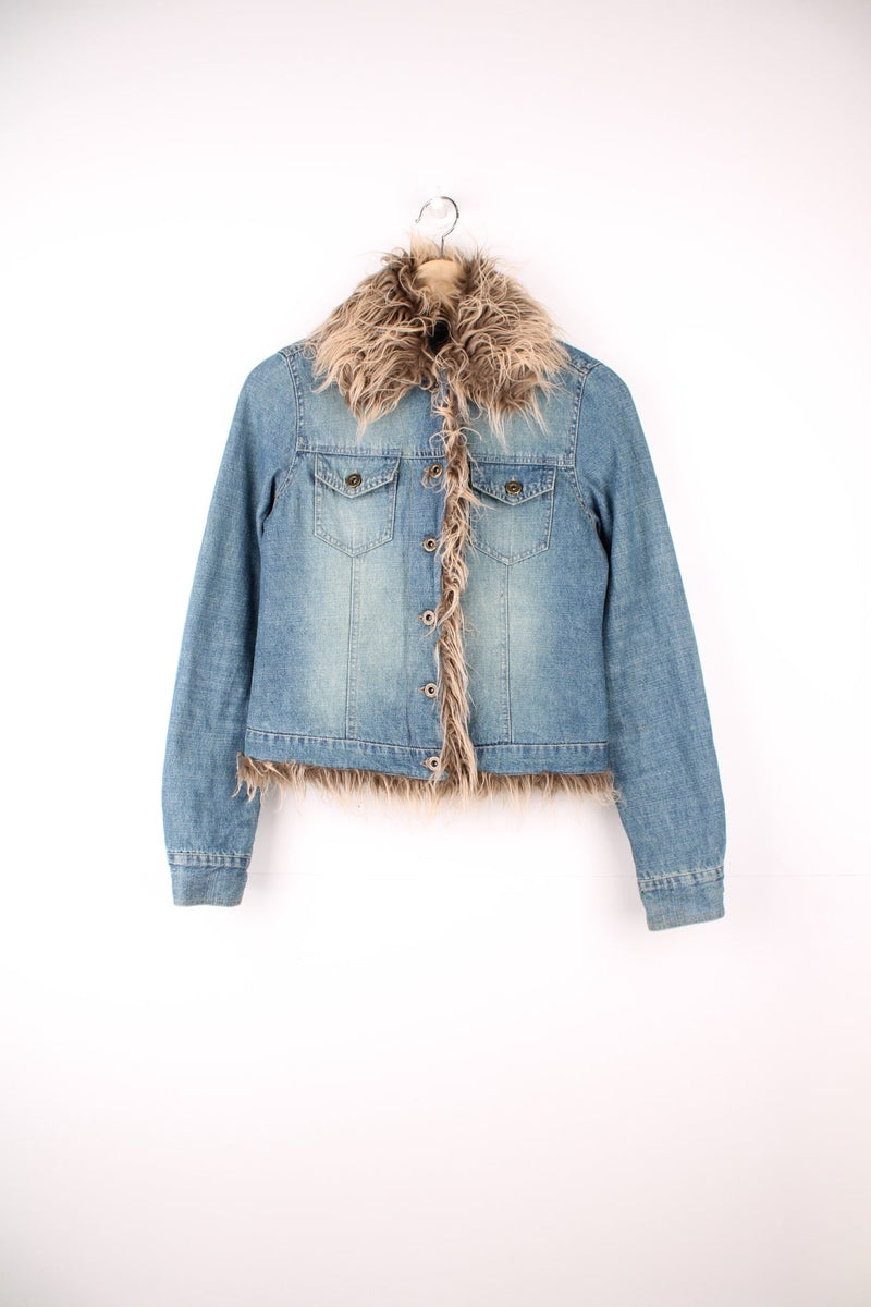 Quilt-lined moto denim jacket with detachable faux fur trim, button closure and two flap breast pockets. 