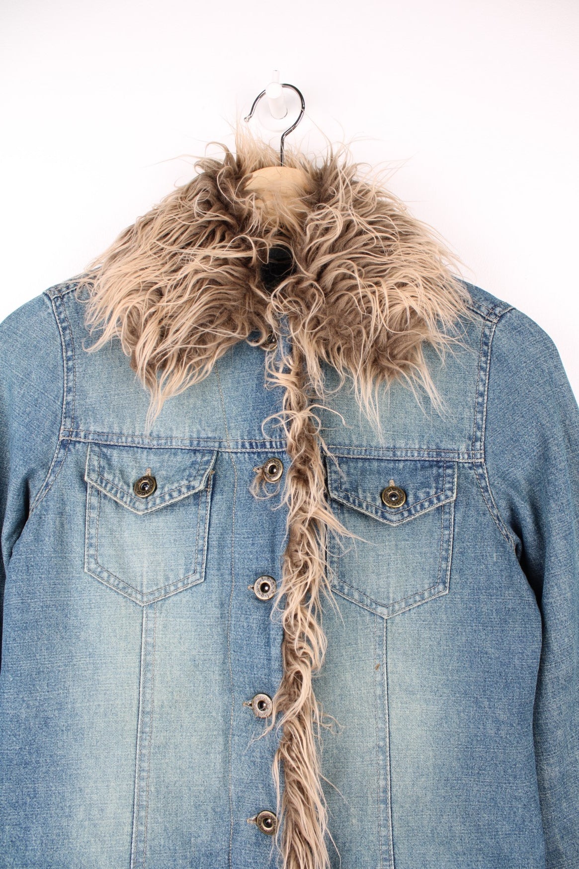 Quilt-lined moto denim jacket with detachable faux fur trim, button closure and two flap breast pockets. 