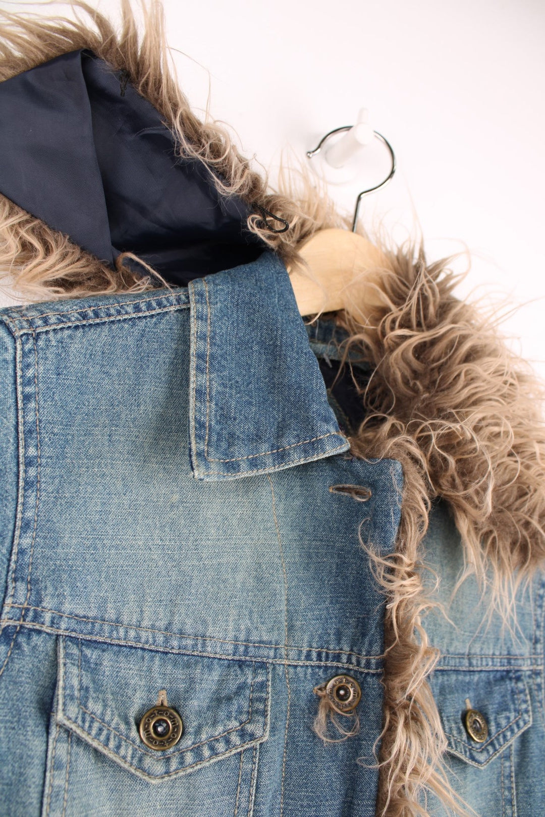 Quilt-lined moto denim jacket with detachable faux fur trim, button closure and two flap breast pockets. 