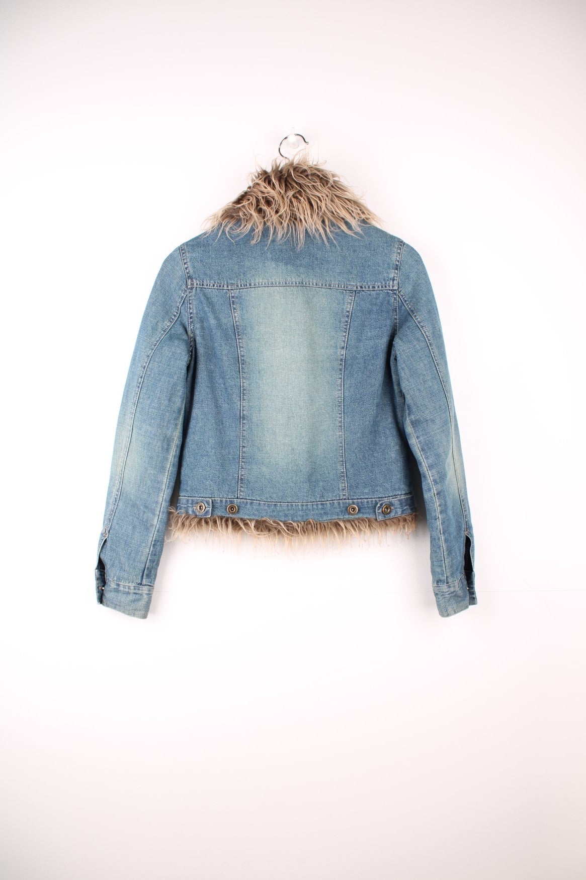 Quilt-lined moto denim jacket with detachable faux fur trim, button closure and two flap breast pockets. 