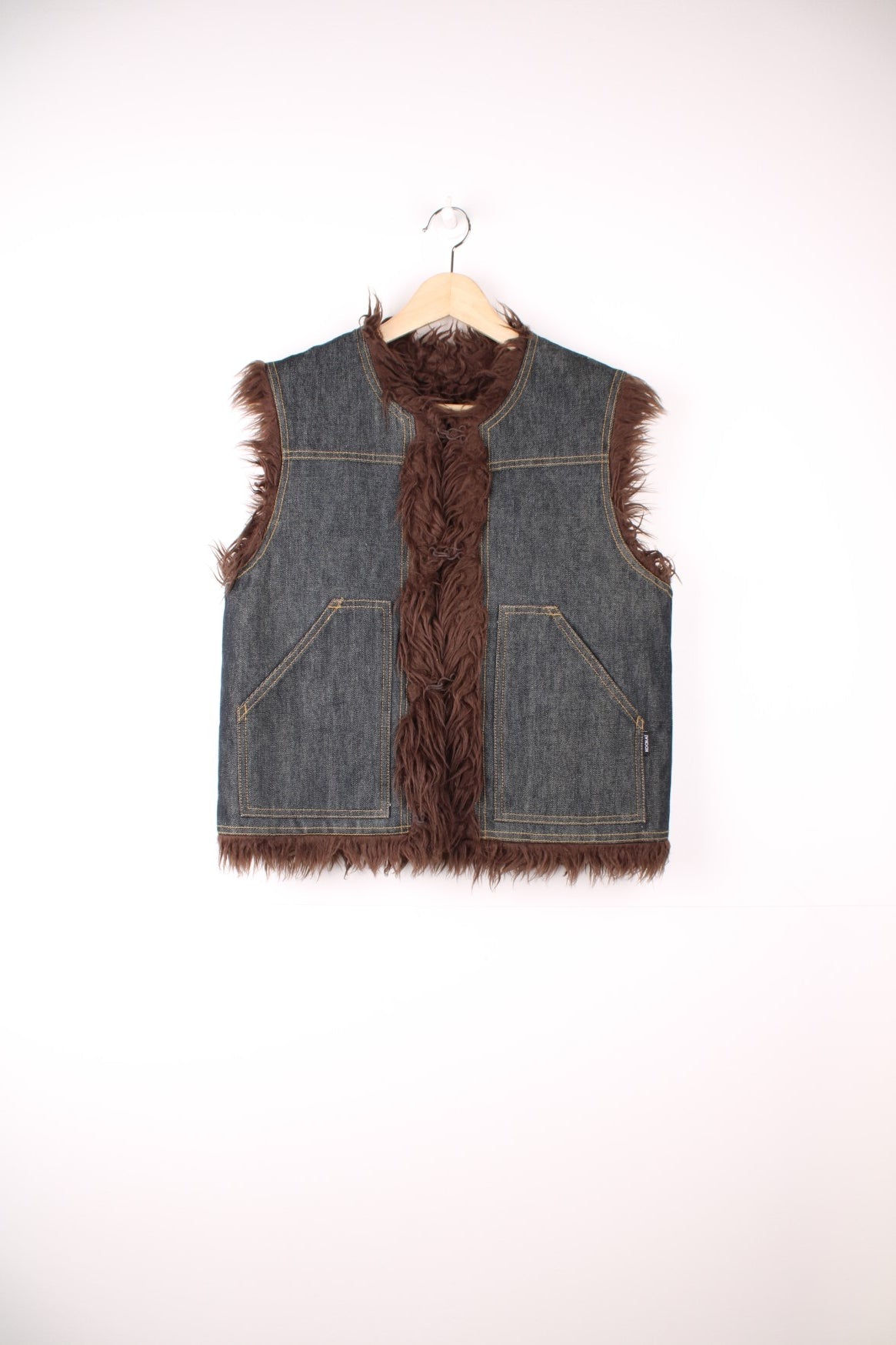 Y2K blue denim vest with brown faux fur lining, two patch pockets and hook closure.