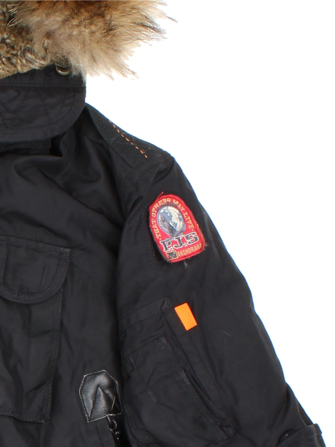 Parajumpers Gobi down coat in black with multiple utility pockets, a velcro logo patch, fur-lined hood, and a PJS carabiner attached.