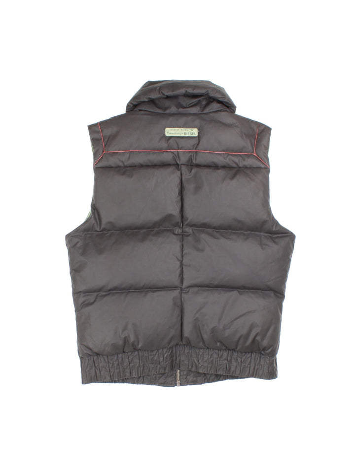 Diesel puffer gilet in brown with three pockets, a branded patch on the back, orange contrast stitching, and zip closure.