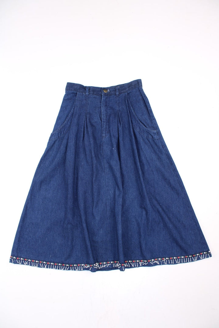 Vintage Denim Skirt in blue colourway with floral bead patterns embroidered on the hem, high waisted and has side pockets.