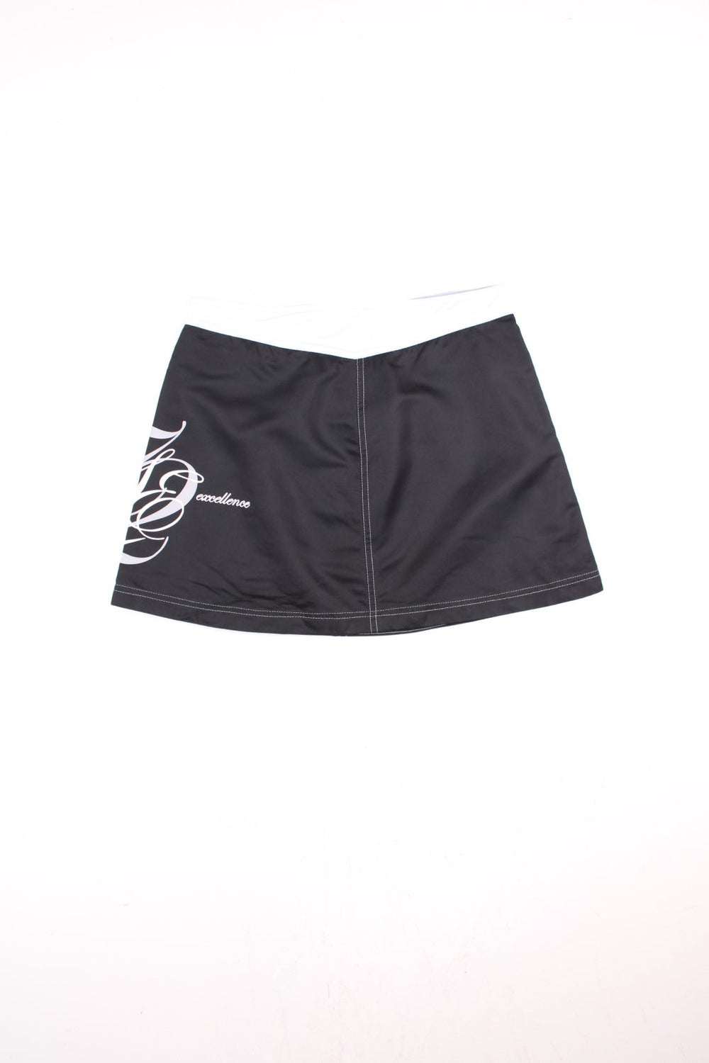 Y2K Nike Sporting Excellence Mini Skirt in black and white colourway with the logo and graphic spell out printed around the left side.