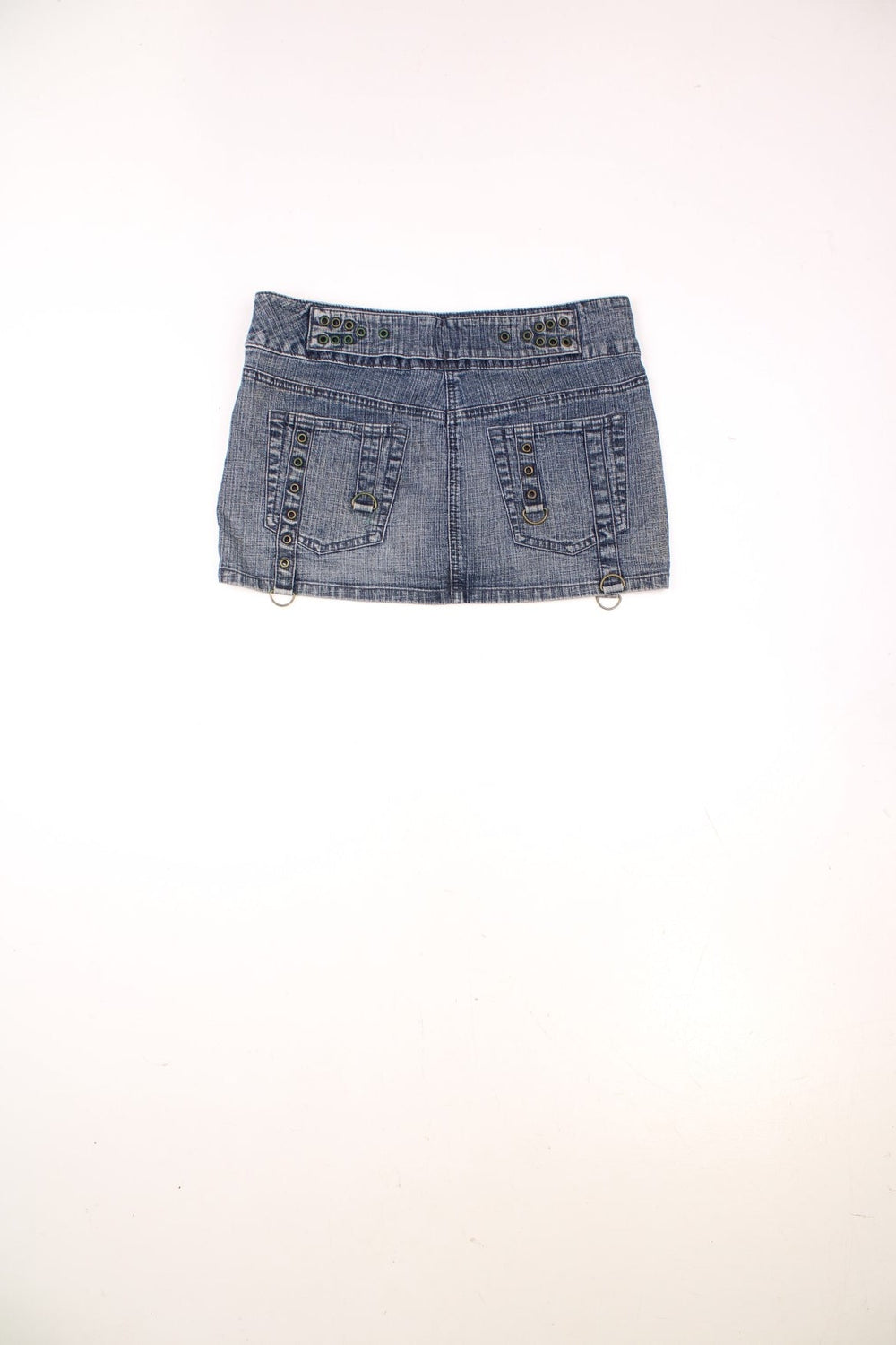 Y2K Moto by Topshop denim mini skirt with zip closure, rivet detailing, front and back pockets, and an attached belt with a large circular buckle. 