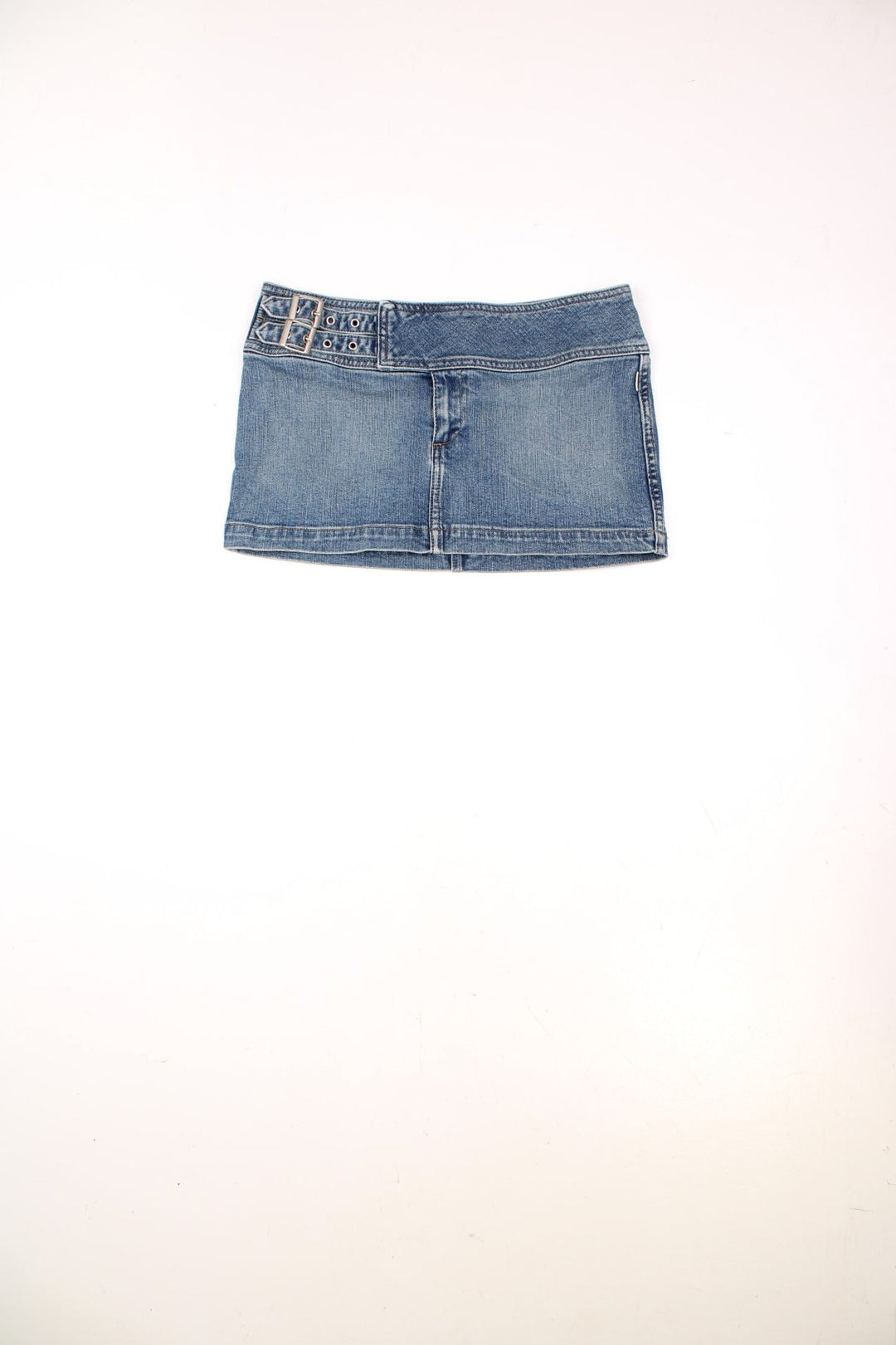 Y2K Bench denim mini skirt with belt buckle detailing, zip closure, and a spellout on the back. 