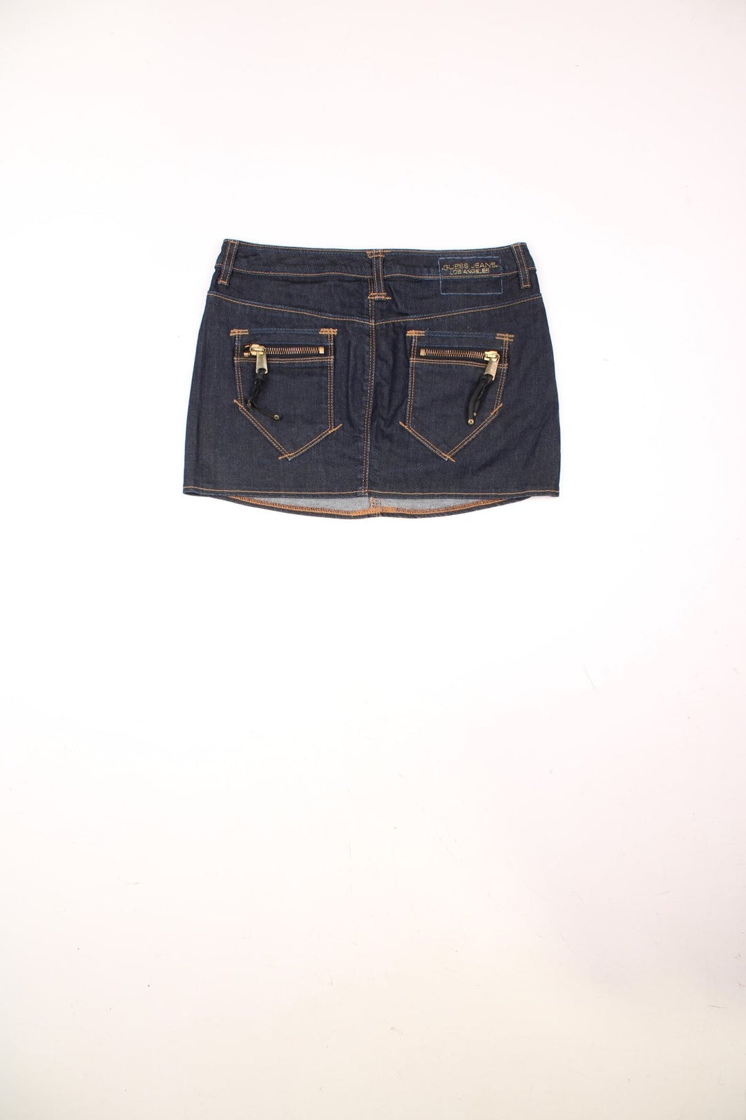 Y2K dark wash denim mini skirt by Guess Premium with zip and button closure, and front and back pockets. 