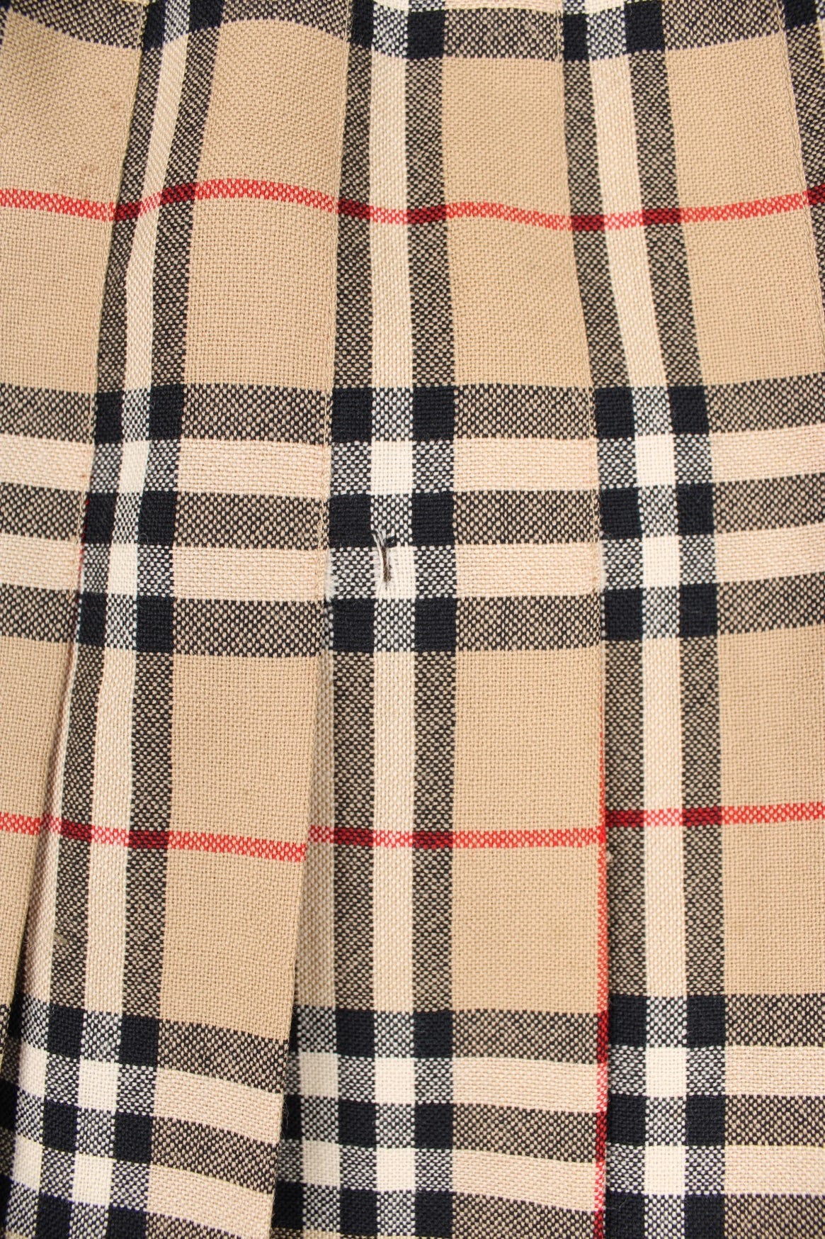 Vintage Burberry (then Burberrys) pleated wool midi skirt in the signature brown, black and red Burberry plaid pattern. Has a metal hook and zip fastening on the side. 