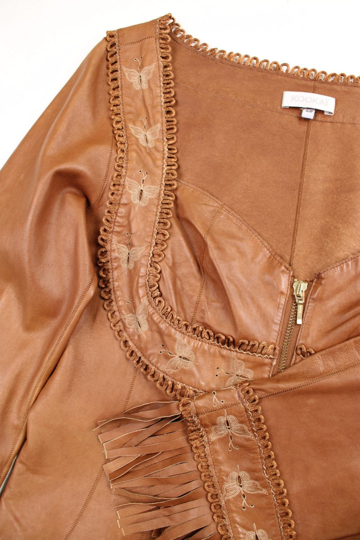 Y2K Kookai zipped brown leather milkmaid top with butterfly embroidery and fringe on the cuffs. 