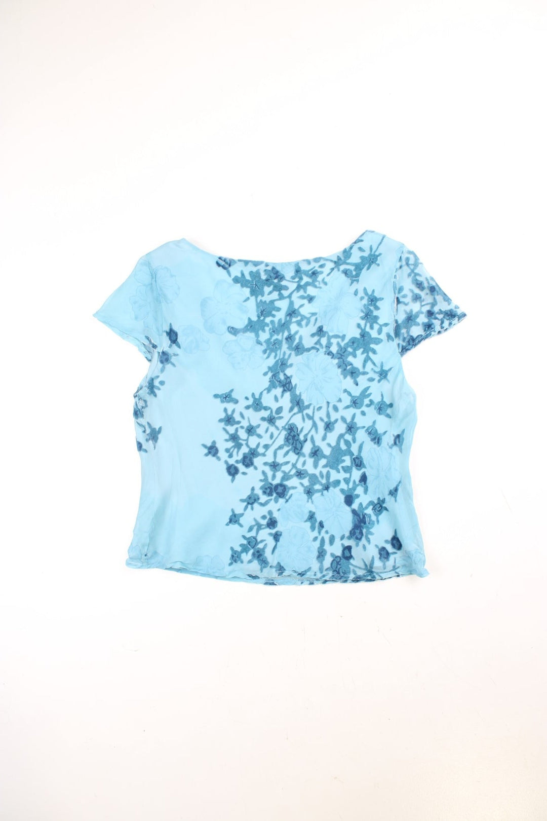 Y2K Monsoon floaty top in blue with cap sleeves, a ruched bust, and velvet floral appliqué.