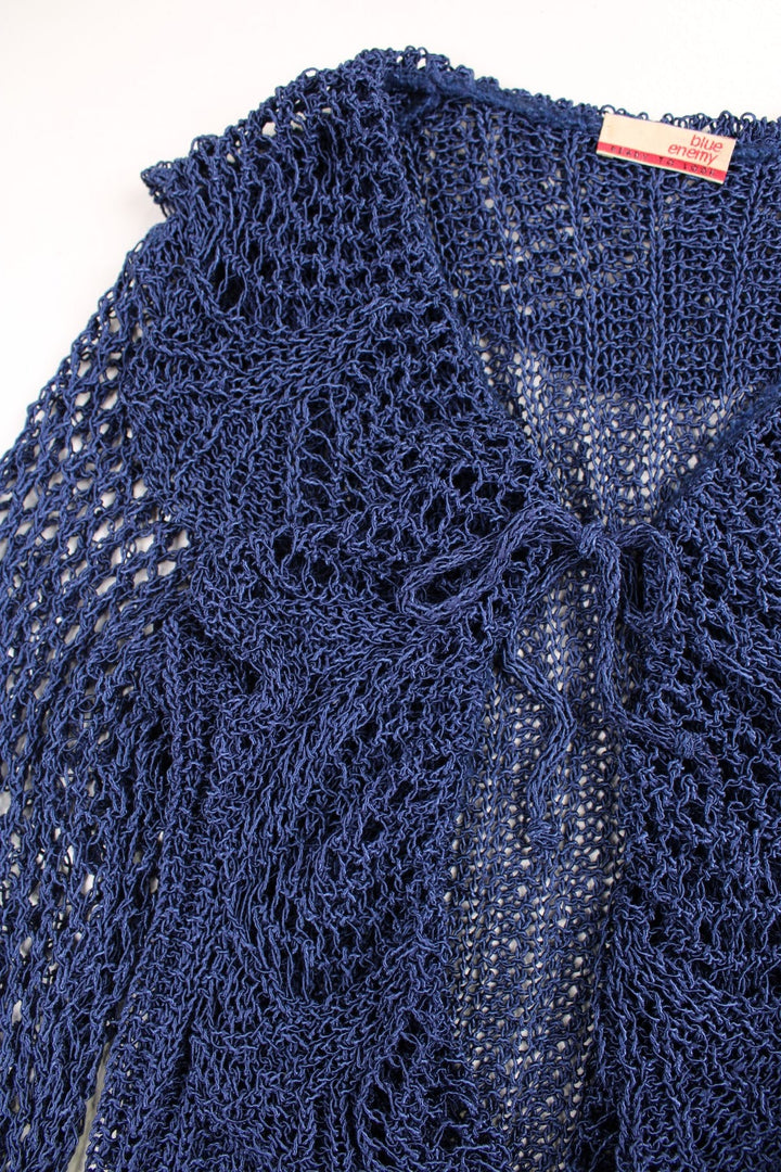 Y2K crochet top in blue with a ruffled collar, fluted sleeves, and tie-up closure.