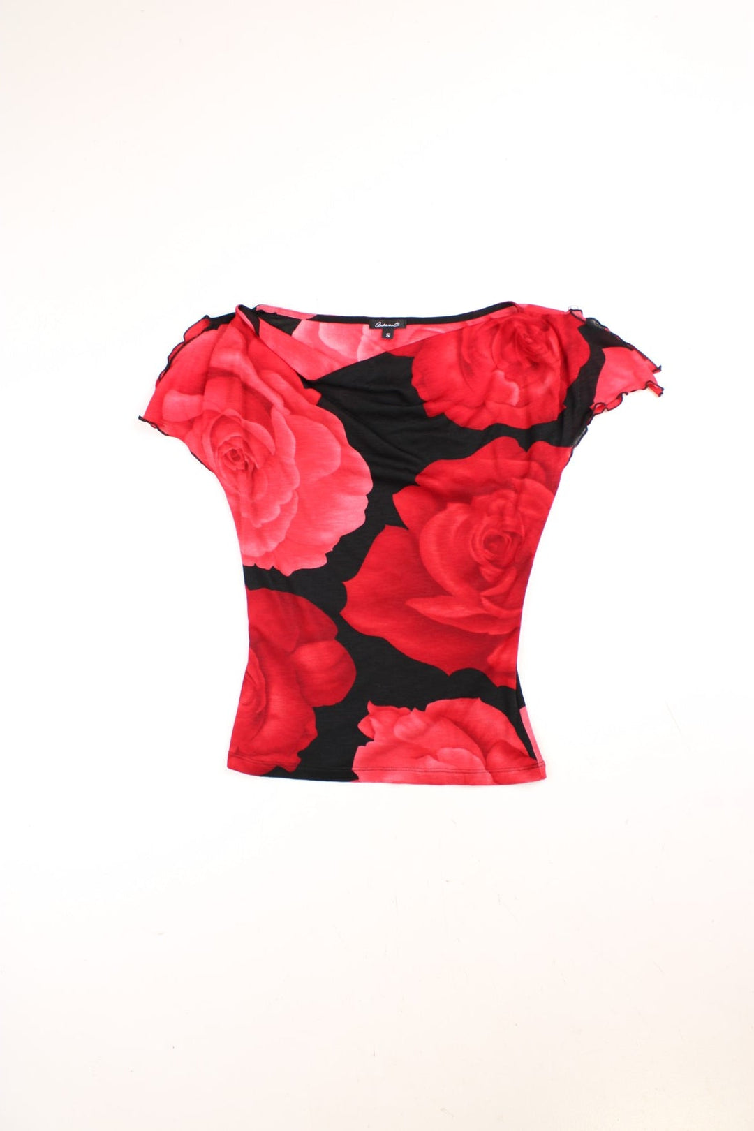 Y2K cowl neck top in red with a large rose print on a black background and split cap sleeves.