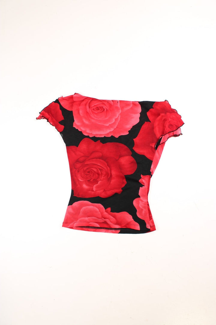 Y2K cowl neck top in red with a large rose print on a black background and split cap sleeves.