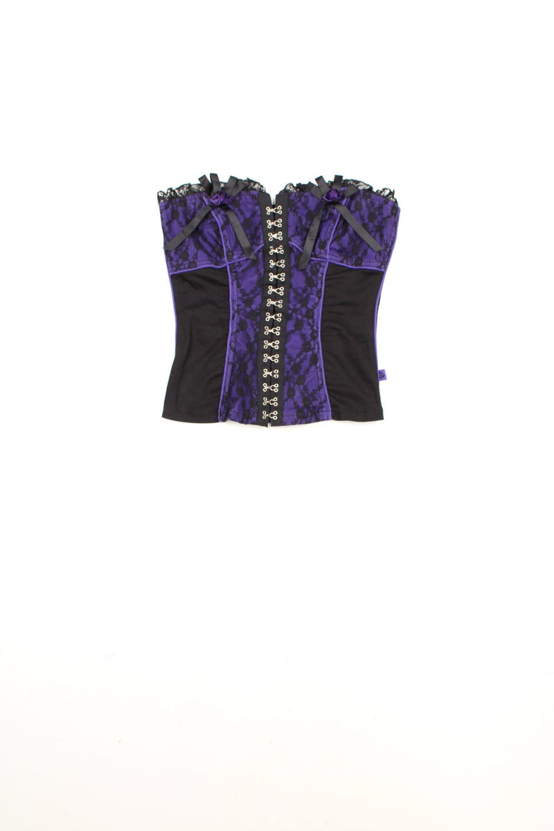 Tripp NYC black and purple corset with lace and ribbon details and metal hook fastenings down the front.