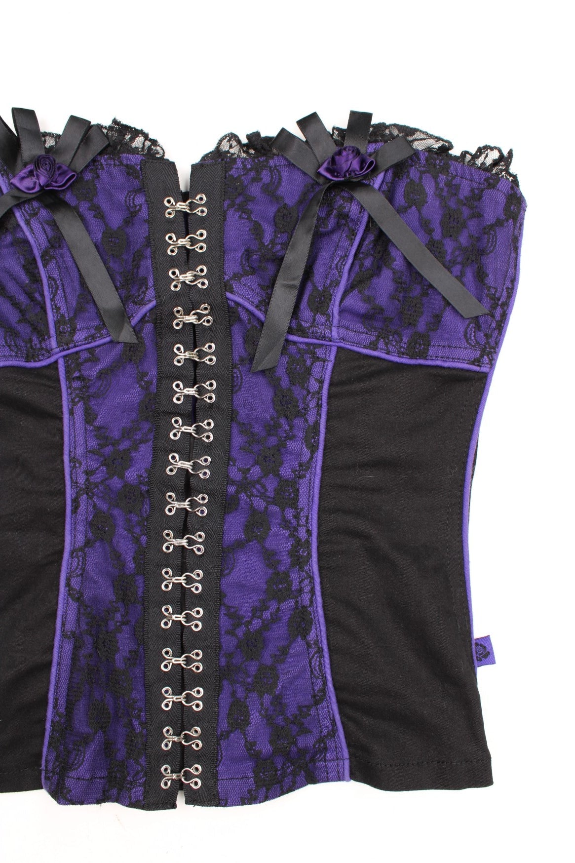 Tripp NYC black and purple corset with lace and ribbon details and metal hook fastenings down the front.