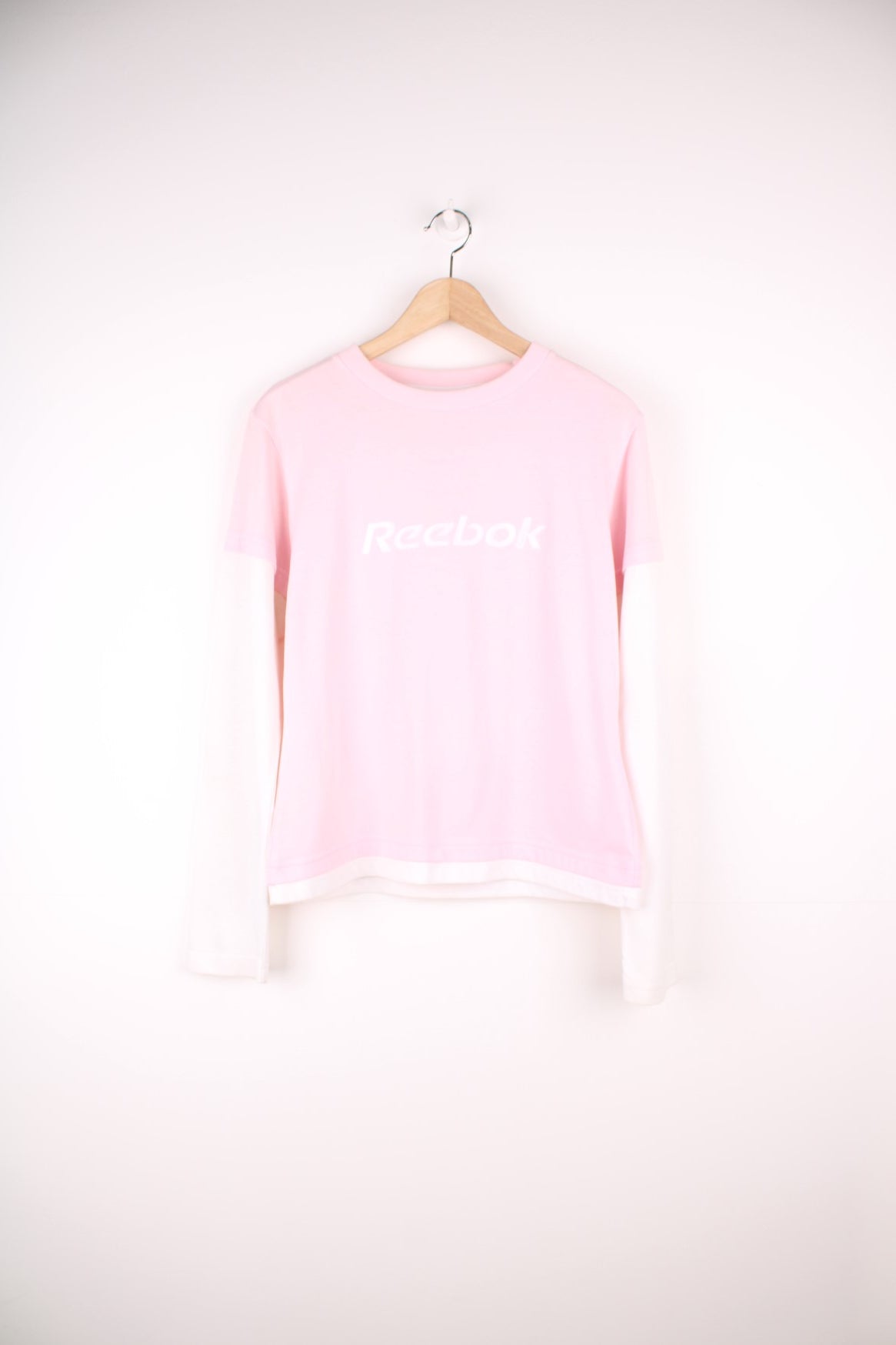 Reebok long sleeved top in pink and white with embroidered spell out logo across the chest. 