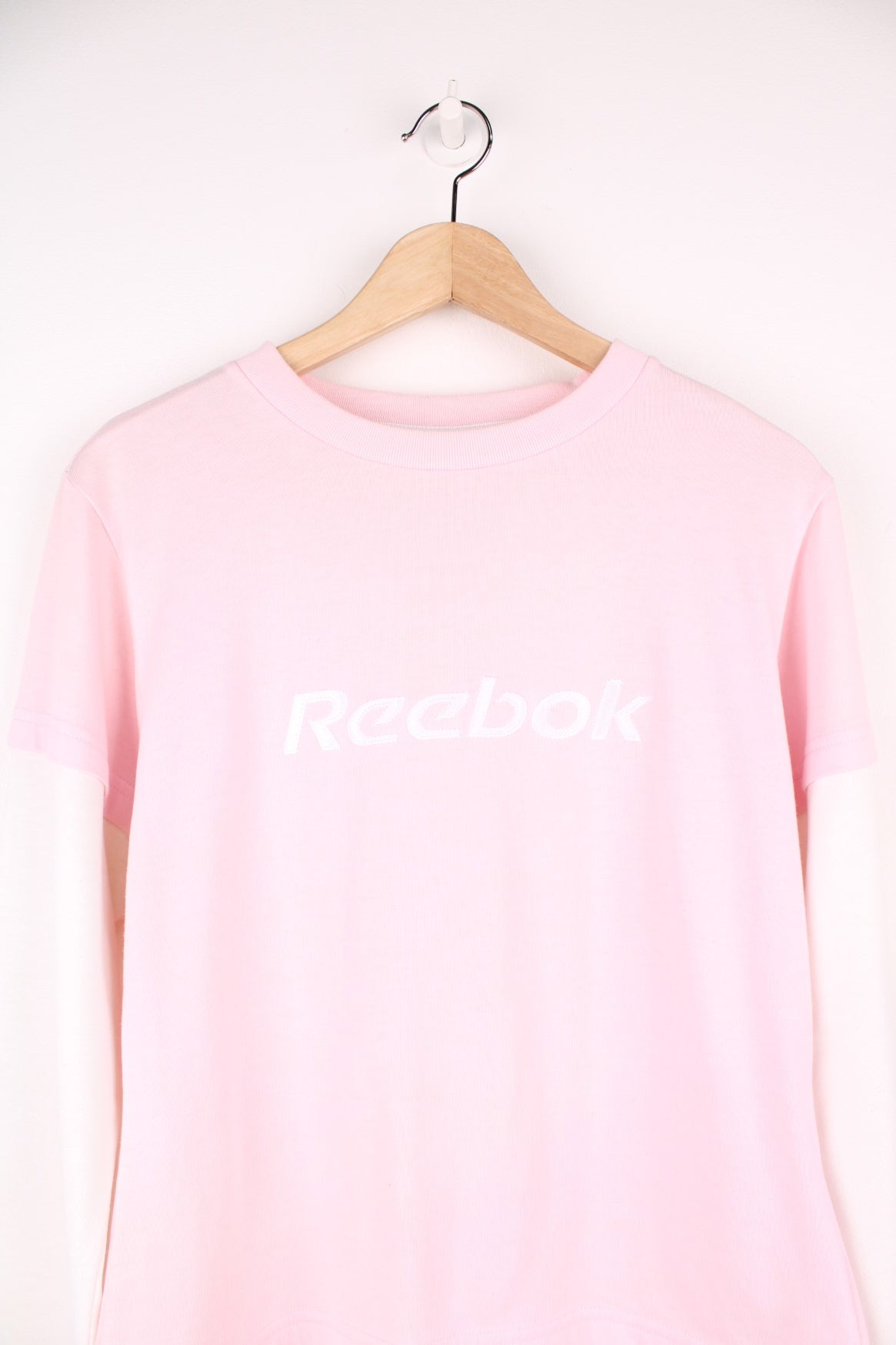 Reebok long sleeved top in pink and white with embroidered spell out logo across the chest. 