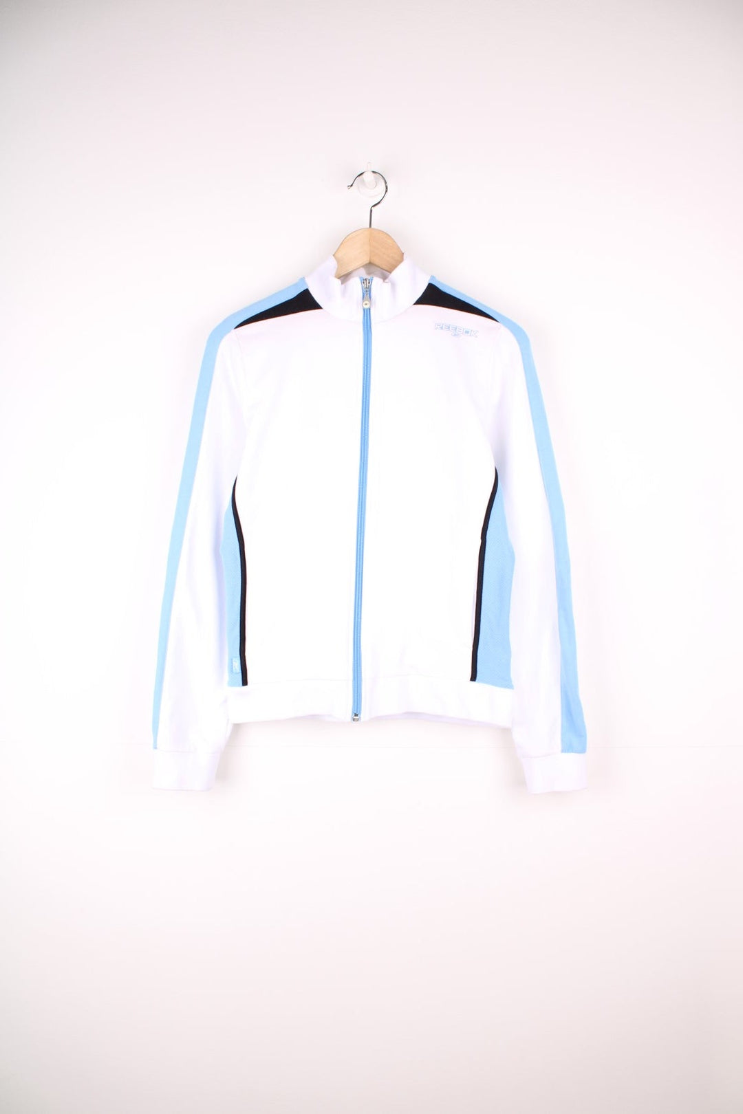 White Reebok zip through sweatshirt with blue stripe down each sleeve and puff printed logo.