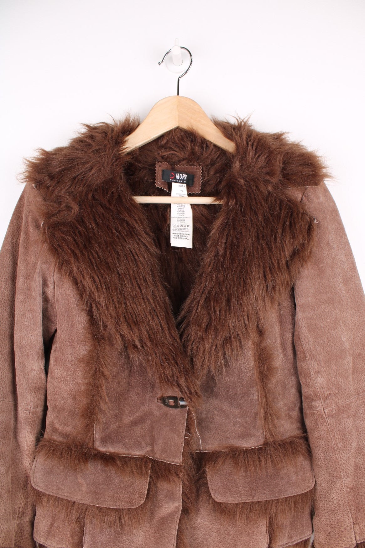 Morgan De Toi Afghan Coat in a brown colourway, leather shell with a faux fur lining, singular button up and also has a pompom belt.