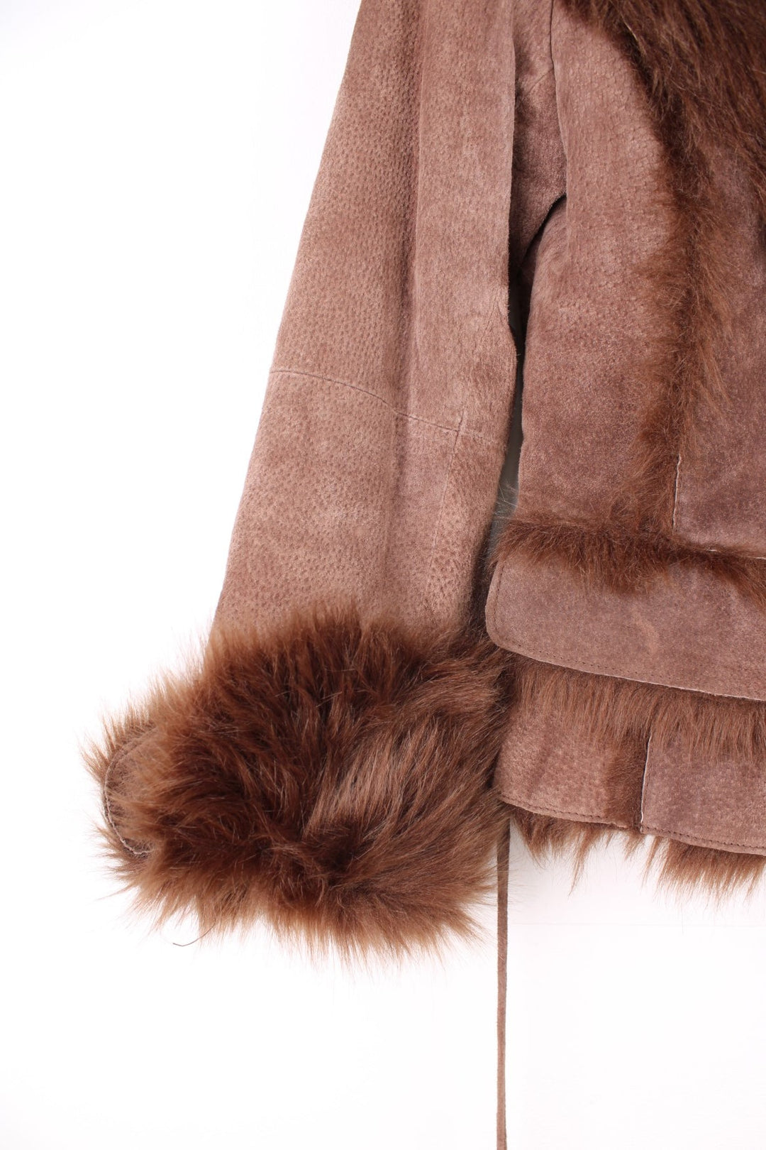 Morgan De Toi Afghan Coat in a brown colourway, leather shell with a faux fur lining, singular button up and also has a pompom belt.