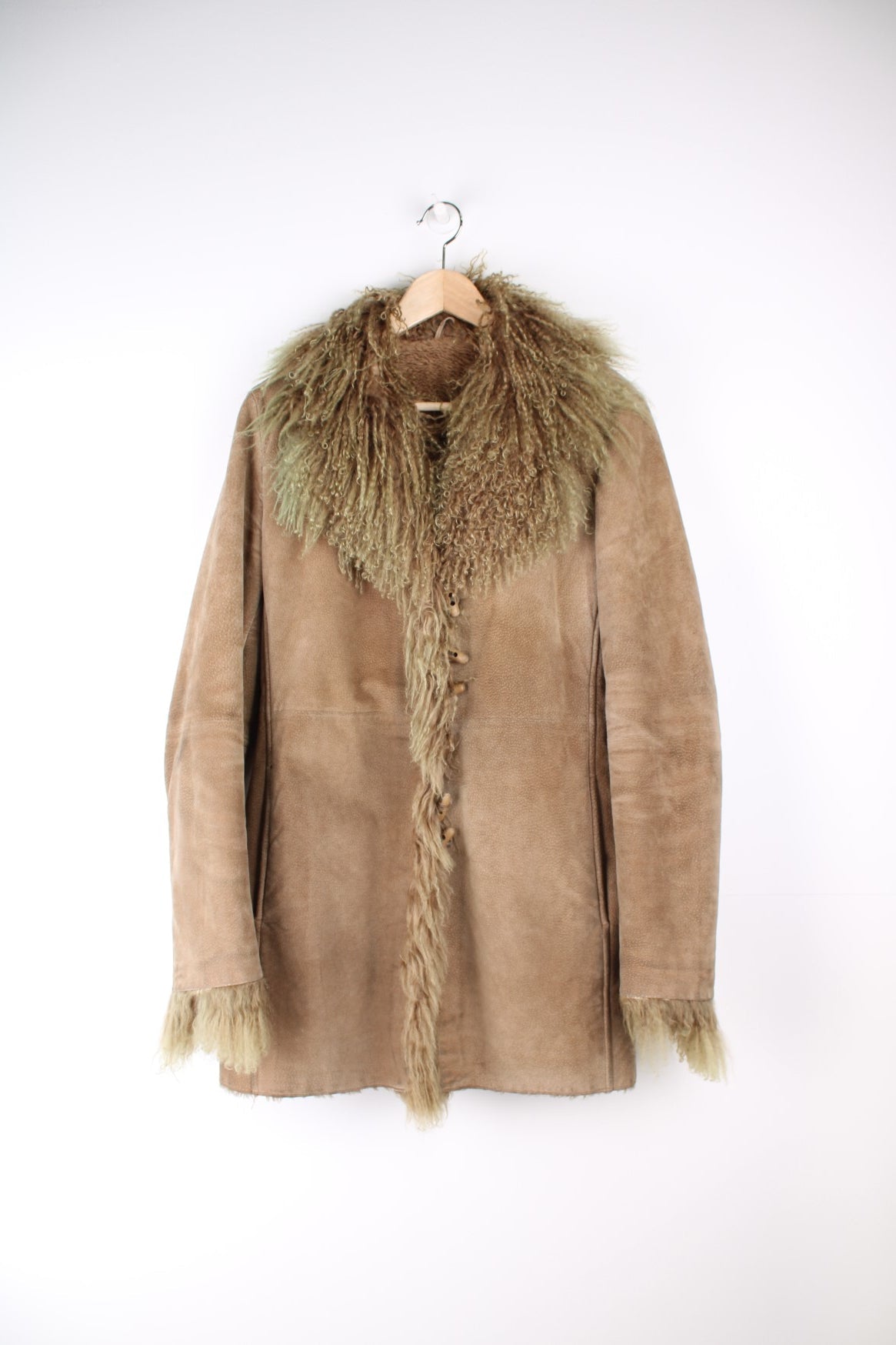 Vintage Afgan Coat in a brown colourway with a tanned / green fur lining on the collar and around the jacket, button up and has side pockets.