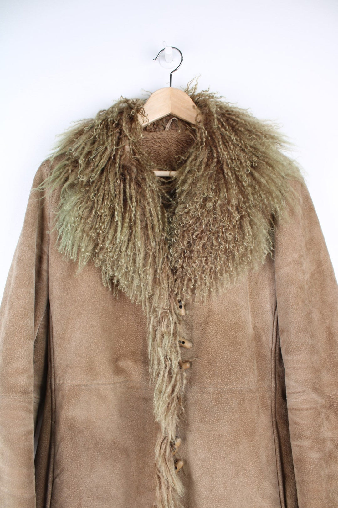 Vintage Afgan Coat in a brown colourway with a tanned / green fur lining on the collar and around the jacket, button up and has side pockets.