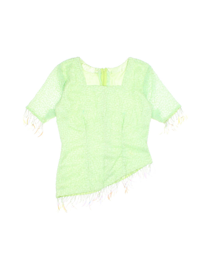 Y2K beaded top in pale green with an asymmetrical hem, beading throughout and zip closure.