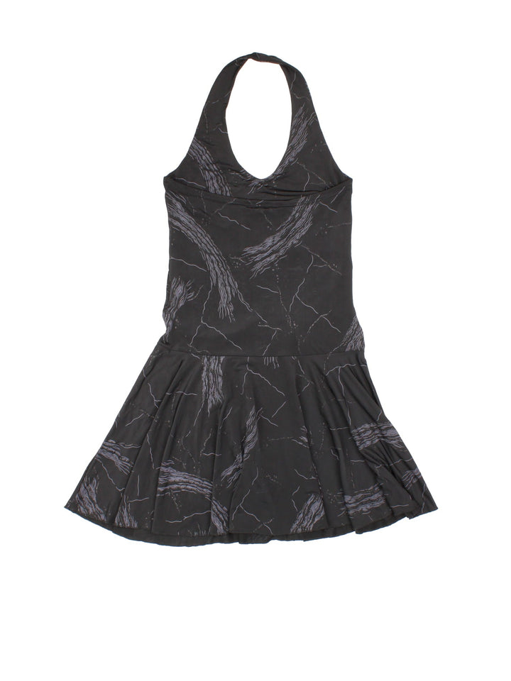 Y2K halter neck mini dress in black with abstract glittery squiggle detailing and an attached belt with large silver buckle by Blind Date.