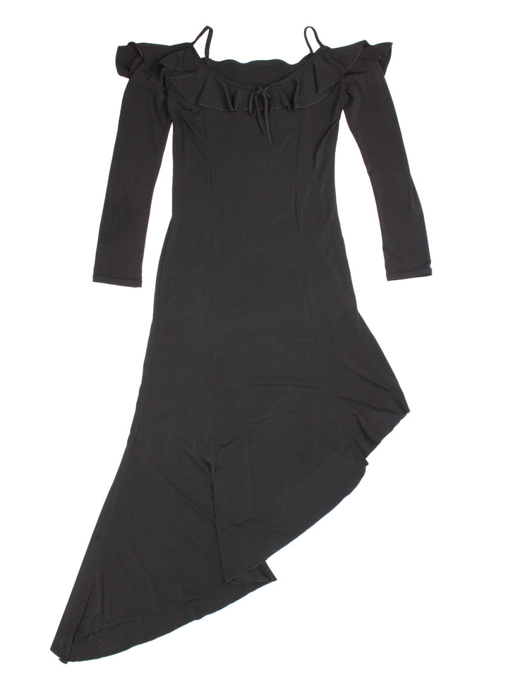 Y2K maxi dress in black with ruffle detailing, a small bow in the front, and an asymmetrical hem.