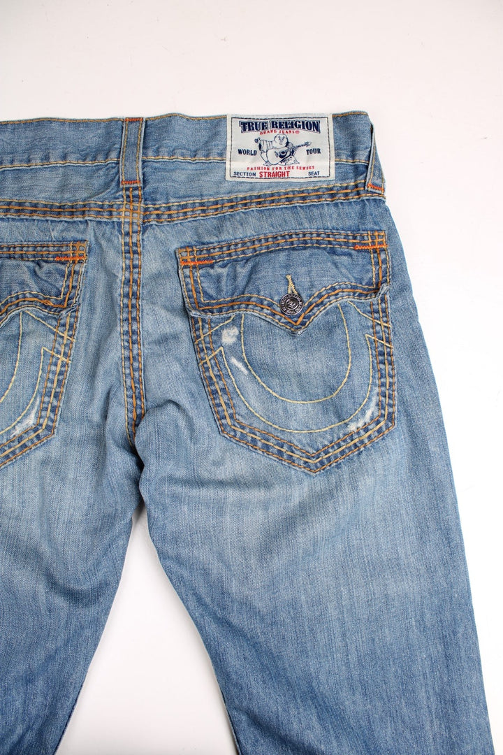 Y2K  jeans in light  denim colourway with pockets and the logo embroidered on the back.