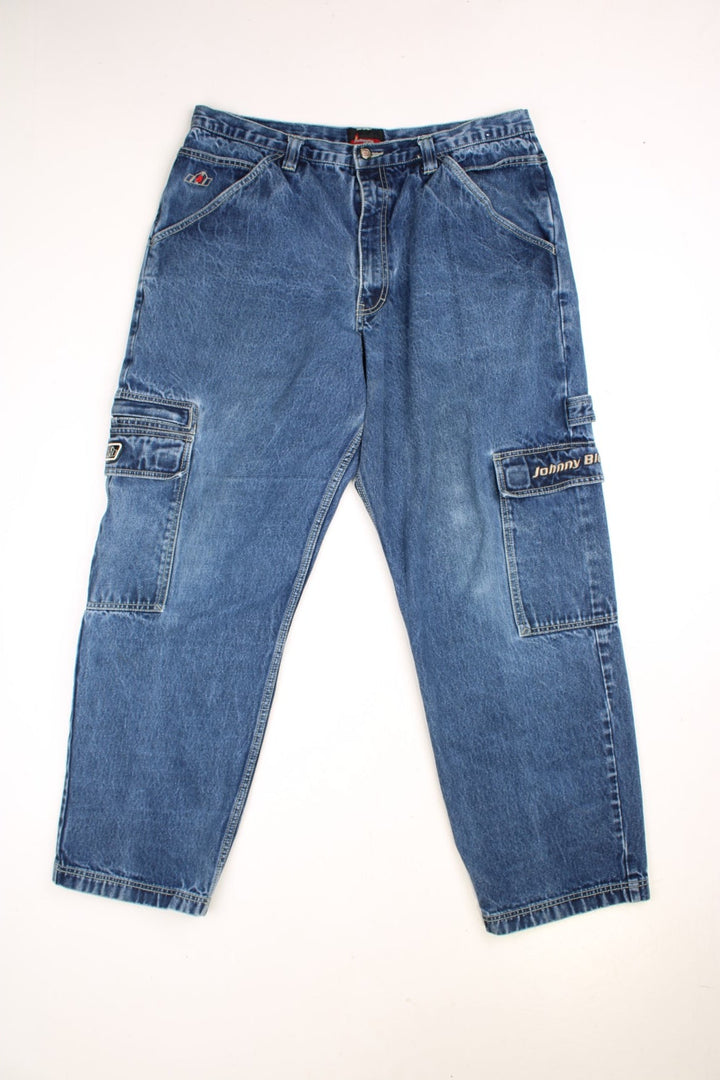 Johnny Blaze Y2K Baggy Cargo Jeans in blue colourway with multiple pockets and the logo embroidered on the pockets.