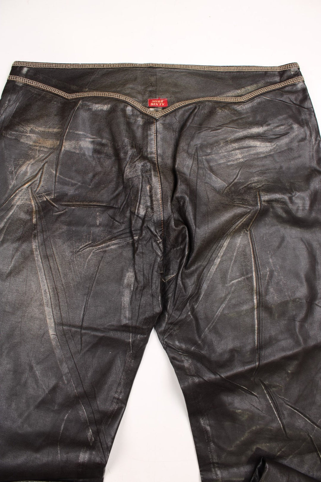 Y2K  Flared Pleather Trousers in  colourway with pockets, low rise, and has the logo embroidered on the back.